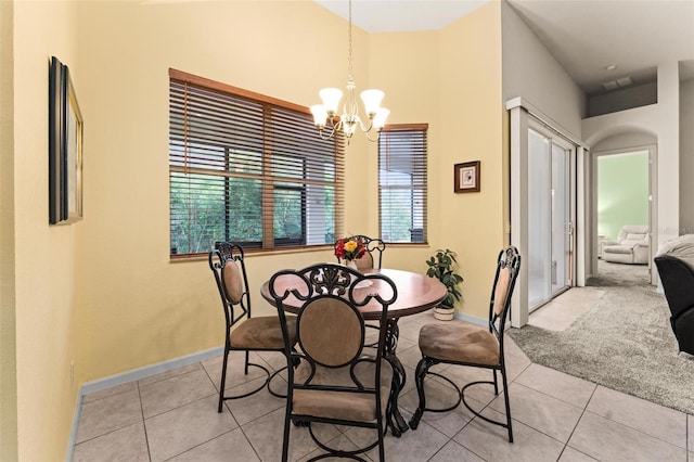 dining room featuring light tile patterned floors, plenty of natural light, and a chandelier