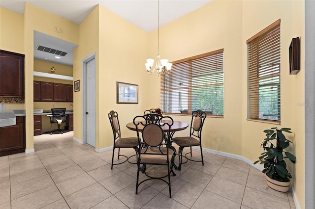 tiled dining space with a chandelier