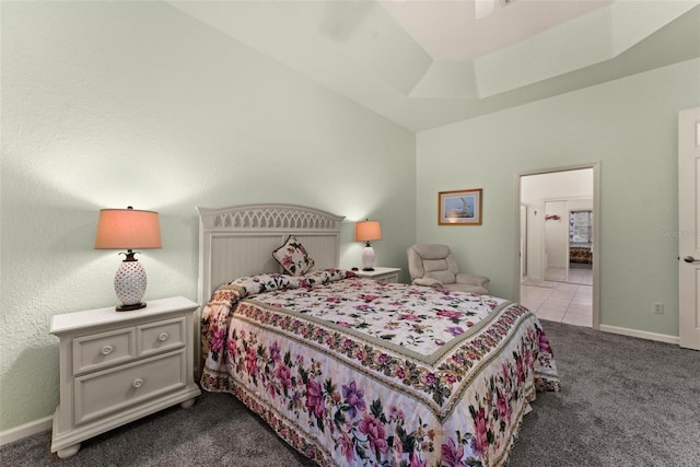 bedroom with ceiling fan, carpet flooring, and a raised ceiling