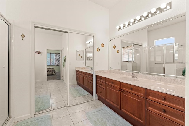 bathroom featuring vanity, a shower with door, and tile patterned floors