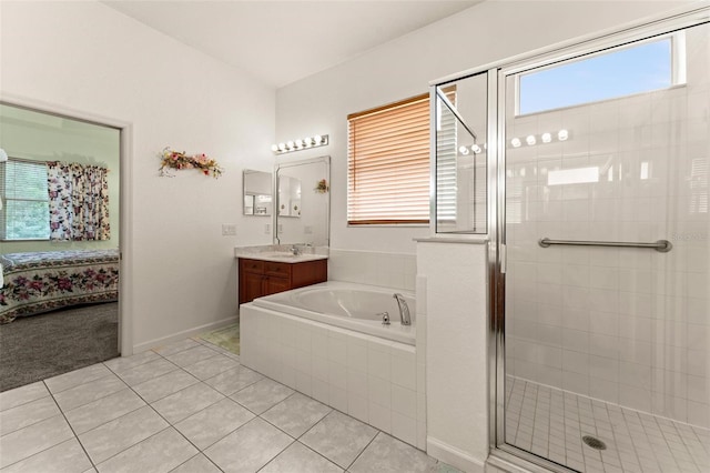 bathroom featuring separate shower and tub, vanity, and tile patterned flooring