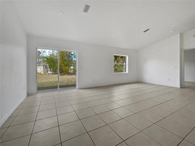 tiled empty room featuring a healthy amount of sunlight