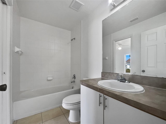 full bathroom with toilet, vanity, tile patterned floors, and tiled shower / bath