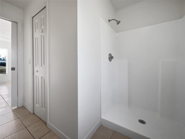 bathroom featuring tile patterned flooring and a shower