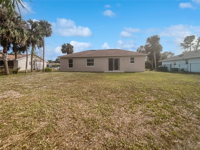 back of property featuring a yard