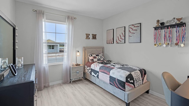 bedroom featuring light wood-type flooring and multiple windows