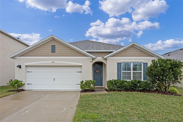 ranch-style house featuring a garage and a front yard