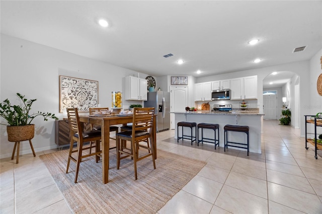 dining space featuring light tile patterned floors