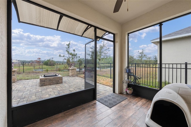 sunroom featuring ceiling fan