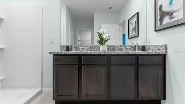 bathroom featuring vanity and walk in shower