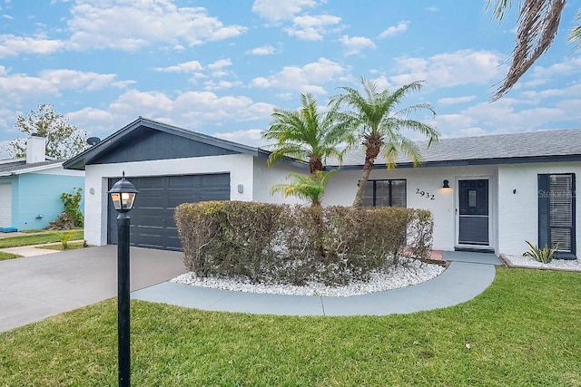 ranch-style house featuring a front yard and a garage