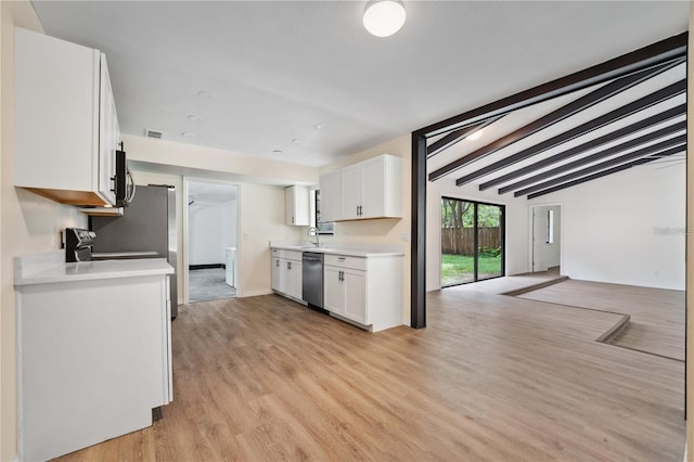 kitchen featuring light wood finished floors, stainless steel appliances, light countertops, lofted ceiling with beams, and white cabinets