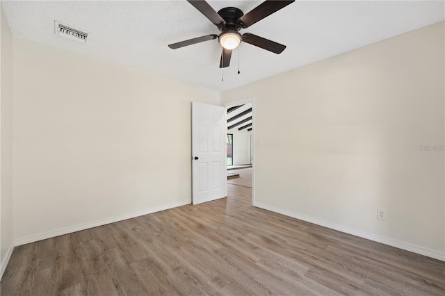 unfurnished room featuring ceiling fan and hardwood / wood-style floors