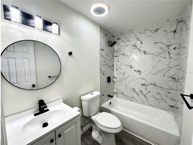 bathroom featuring shower / bath combination, a textured wall, toilet, vanity, and wood finished floors