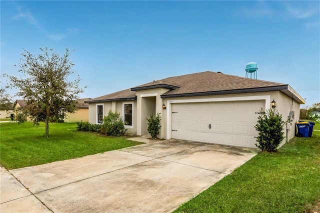 view of front of home featuring a garage and a front yard