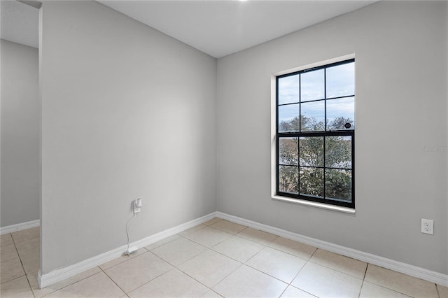 unfurnished room with light tile patterned floors