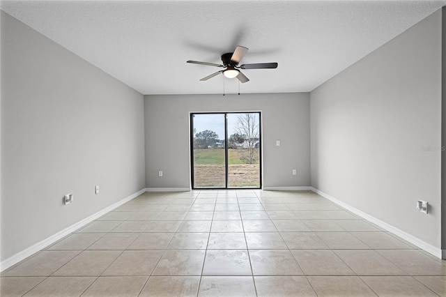 unfurnished room with light tile patterned flooring, ceiling fan, and a textured ceiling