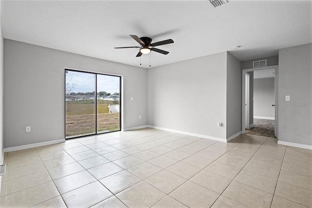 unfurnished room featuring light tile patterned flooring, a textured ceiling, and ceiling fan