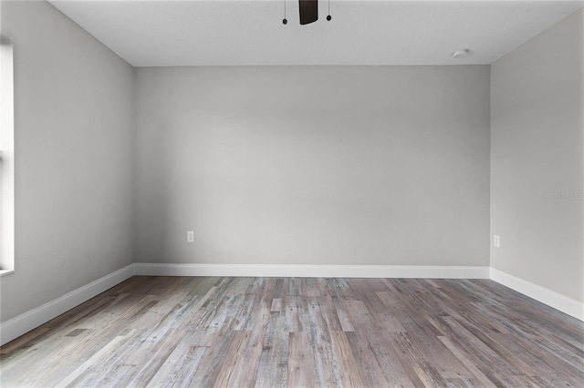 empty room with ceiling fan and light wood-type flooring