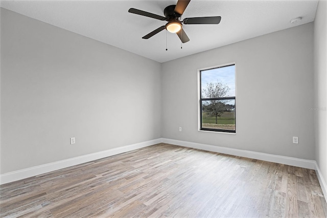 empty room featuring ceiling fan and light hardwood / wood-style flooring