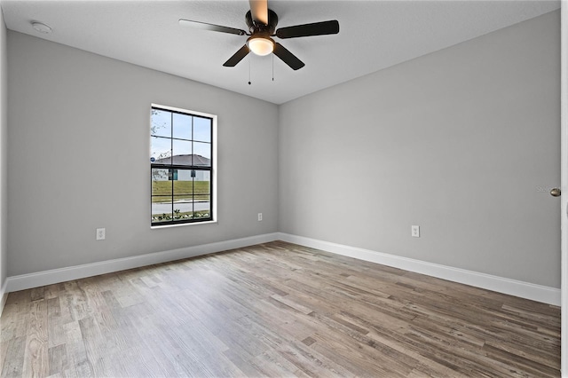 unfurnished room with ceiling fan and light hardwood / wood-style flooring