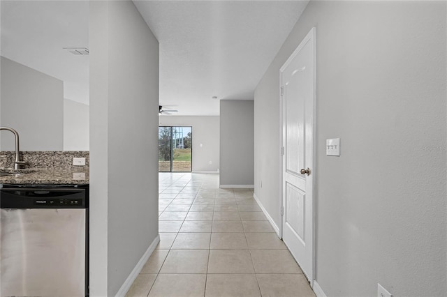 1952 Piedmont Ct, Mascotte, FL 34753 - corridor featuring light tile patterned flooring, a sink, and baseboards