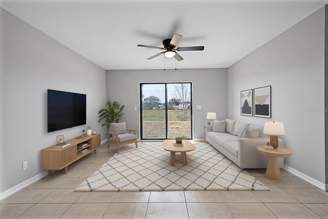 1952 Piedmont Ct, Mascotte, FL 34753 - living room featuring light tile patterned flooring, a ceiling fan, and baseboards