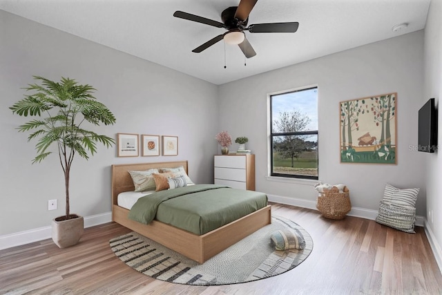 1952 Piedmont Ct, Mascotte, FL 34753 - bedroom with wood finished floors, baseboards, and ceiling fan