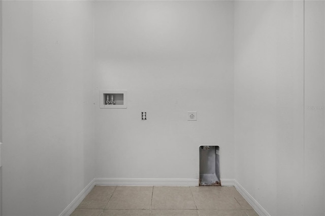 1952 Piedmont Ct, Mascotte, FL 34753 - laundry room with electric dryer hookup, washer hookup, light tile patterned flooring, and baseboards