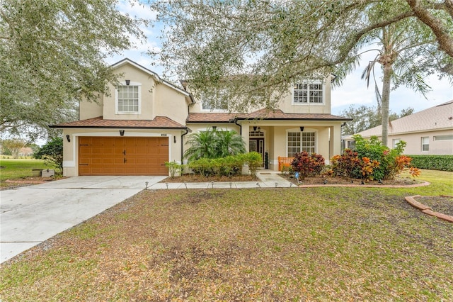 view of front of home featuring a front lawn, a garage, driveway, and stucco siding