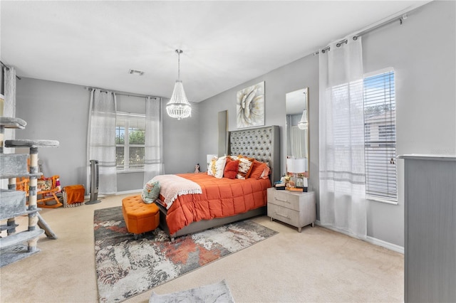 bedroom with light colored carpet and an inviting chandelier