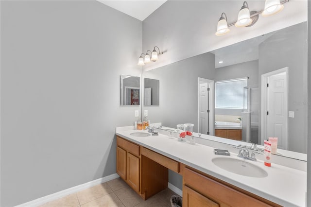 bathroom with a bath, tile patterned floors, and vanity