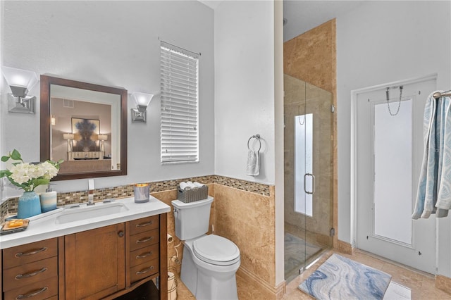 bathroom with toilet, walk in shower, tile walls, tile patterned floors, and vanity