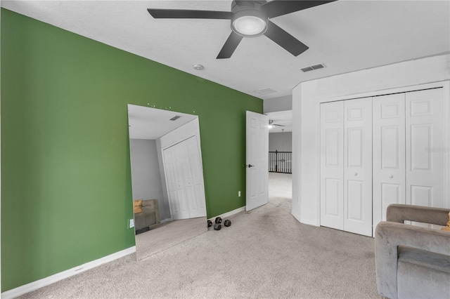 unfurnished bedroom featuring ceiling fan and light colored carpet