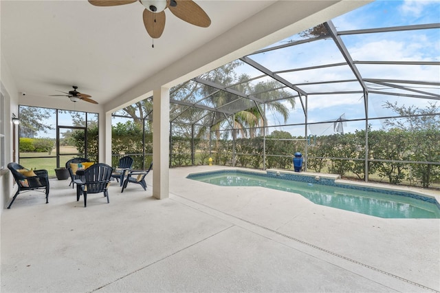 view of pool with ceiling fan, glass enclosure, and a patio