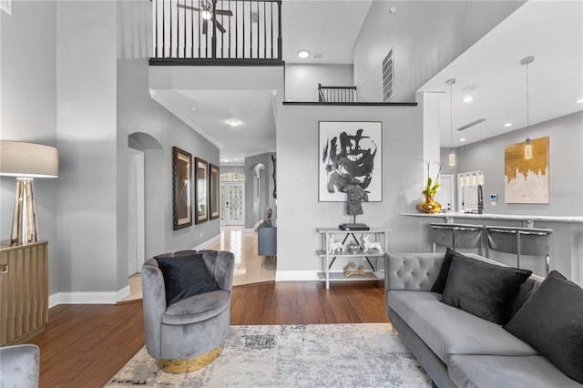 living room with a towering ceiling and hardwood / wood-style floors