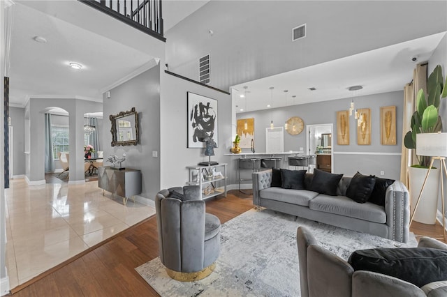 tiled living room featuring crown molding