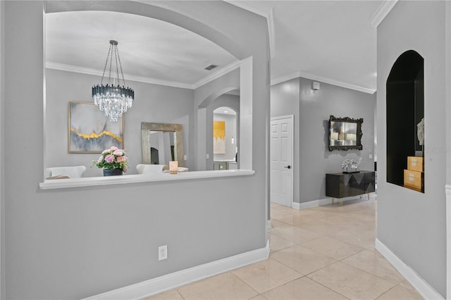 corridor with light tile patterned flooring, crown molding, and a chandelier