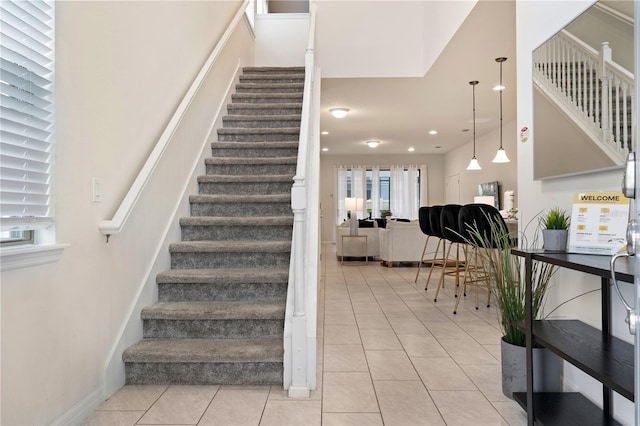 staircase featuring tile patterned flooring