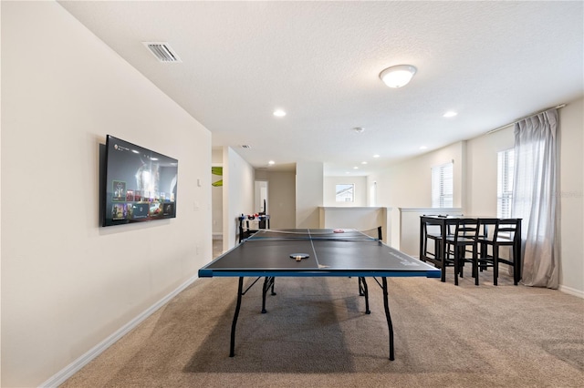 playroom with carpet and a textured ceiling