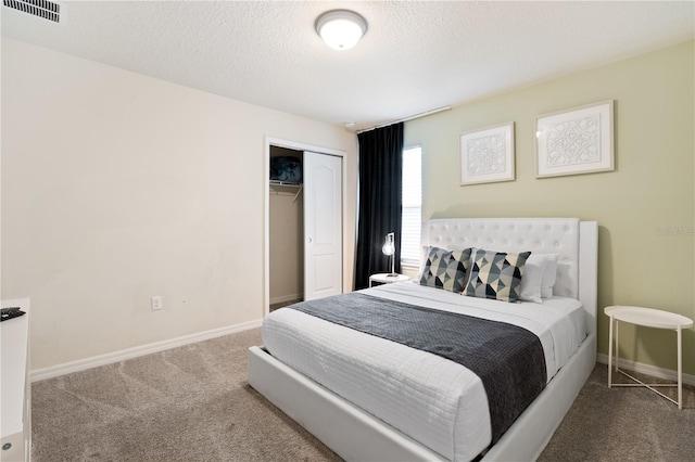 bedroom featuring a closet, carpet flooring, and a textured ceiling