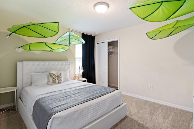 carpeted bedroom with a closet and a textured ceiling