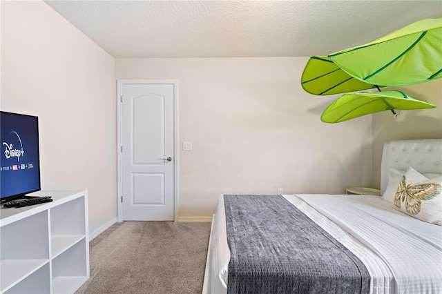 bedroom featuring carpet floors and a textured ceiling