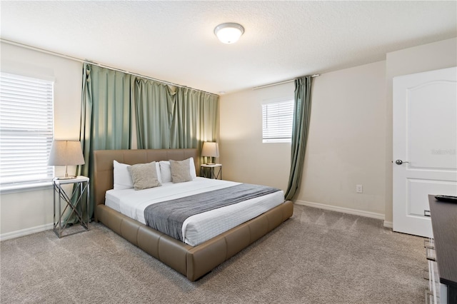 carpeted bedroom featuring multiple windows