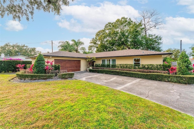 single story home with a front yard and a garage