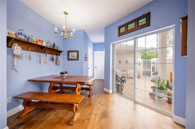 dining space with a chandelier and light wood-type flooring