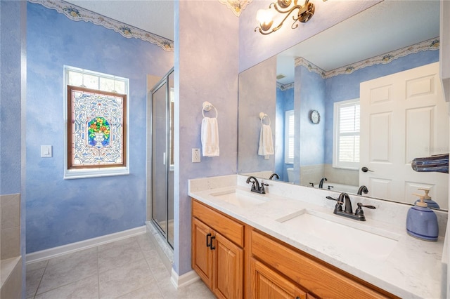 bathroom with tile patterned flooring, vanity, and shower with separate bathtub