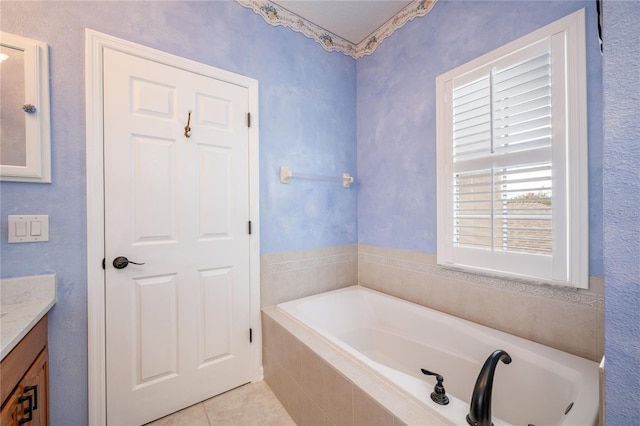 bathroom featuring vanity, tiled bath, and tile patterned floors