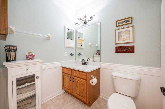 bathroom featuring tile patterned floors, vanity, and toilet