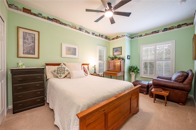 bedroom with light colored carpet and ceiling fan